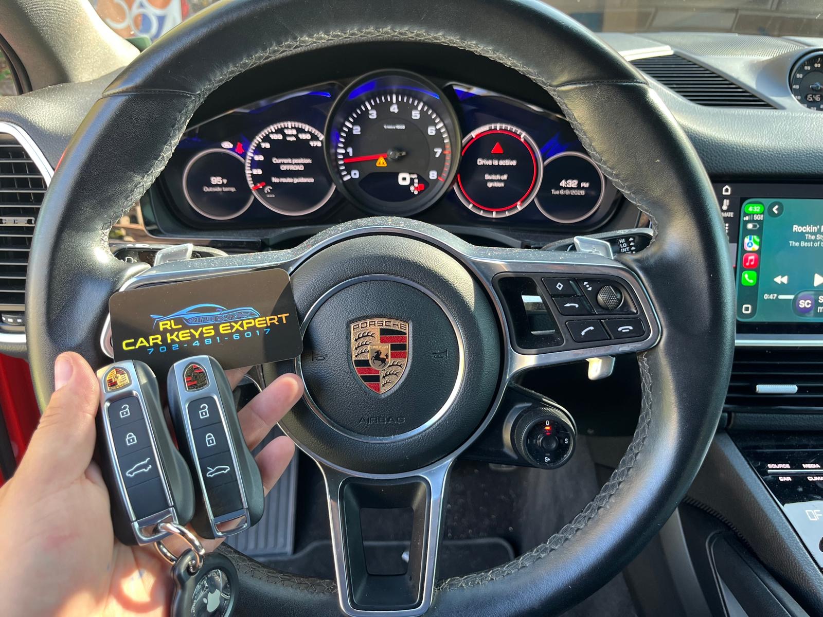 Freshly cut Porsche keys at the steering wheel